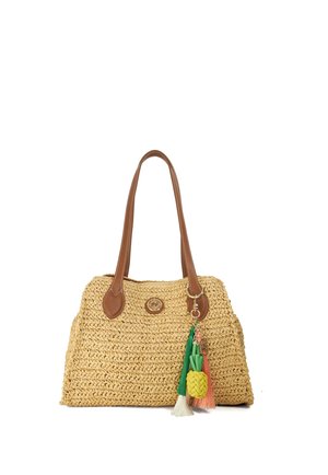 Woven straw handbag with brown leather handles and a colorful pineapple charm with tassels attached on the right side.
