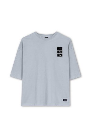 Light blue cotton t-shirt with a crew neck, short sleeves, and a front graphic featuring three black and white images in rectangular frames.