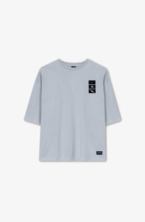 Light blue cotton t-shirt with a crew neck, short sleeves, and a front graphic featuring three black and white images in rectangular frames.