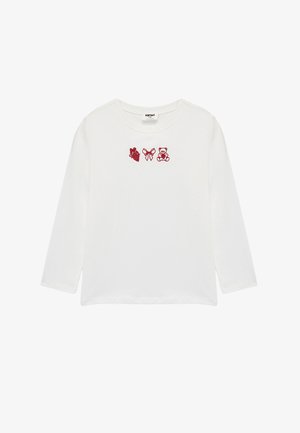 Hvid skjorte med lange ærmer, der har rød broderi af et hjerte, en sløjfe og en bamse på brystet. Blødt bomuldsstof med en rund halsudskæring.