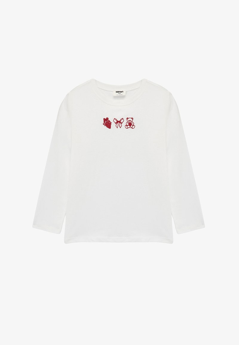 White long-sleeve shirt featuring red embroidery of a heart, bow, and teddy bear on the chest. Soft cotton material with a round neckline.