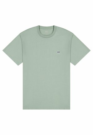 Light green cotton t-shirt with short sleeves, round neckline, and a small navy logo on the left chest. Smooth texture, regular fit.