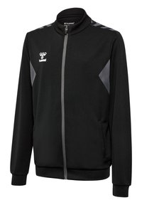 Svart sportjacka med hög krage, dragkedja och gråa accenter på axlarna. Tyget har ett texturerat mönster och ribbade muddar.