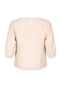 Blusa beige chiaro con vestibilità ampia, maniche a sbuffo, chiusura con bottoni sul retro e cuciture decorative lungo l'orlo. Realizzata in un tessuto testurizzato.
