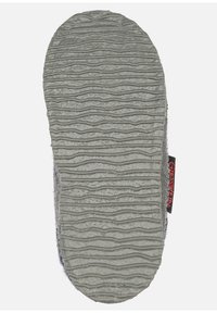 Gray slipper sole with a textured, wavy pattern and a black label featuring red text. Soft, fuzzy upper edge visible.