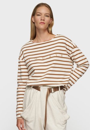Camicia a maniche lunghe a righe color crema con strisce marroni, caratterizzata da una vestibilità rilassata e scollatura rotonda. Testo "10 DAYS" stampato al centro.