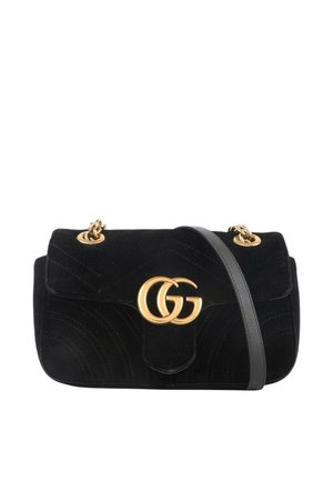 Sac à épaule en velours noir avec logo GG doré, maillons de chaîne dorés et bandoulière en cuir noir.