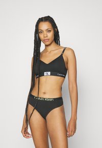 Calvin Klein Underwear MODERN THONG - String - black/sunny lime