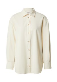 Lichtbeige langemouwen shirt met een klassieke kraag, knopen aan de voorkant en zachte, gladde stof. Heeft een afgeronde zoom en een relaxte pasvorm.