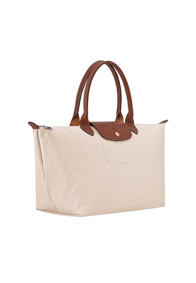 Beige rectangular handbag with brown textured leather handles and flap closure, featuring a gold button and side zipper.