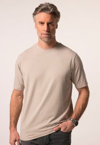 T-shirt beige a maniche corte con collo rotondo, realizzato in tessuto morbido, con un motivo sottile e un piccolo logo sul petto.
