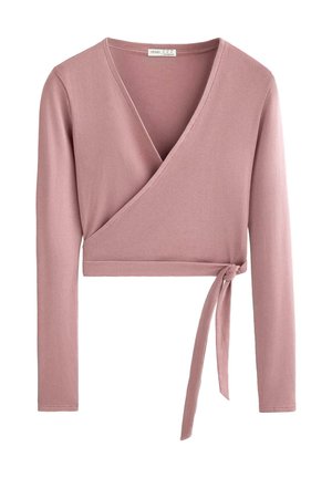 Light pink wrap top made of ribbed fabric, featuring long sleeves, deep V-neckline, and a side tie. Smooth texture with a fitted design.