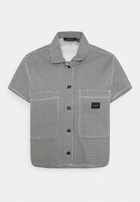 Camicia a maniche corte con motivo pied de poule in bianco e nero, dotata di colletto, chiusura con bottoni e taschino sul petto sinistro con etichetta del marchio.