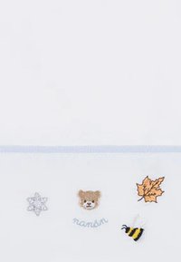 Biała tkanina z haftowanymi wzorami: płatek śniegu, niedźwiedź, liść, pszczółka oraz tekst "mamán" w jasnoniebieskim kolorze. Akcenty są kolorowe i radosne.