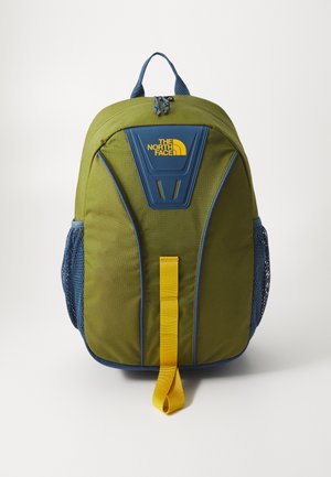 Green fabric backpack with a navy blue accent, featuring a rectangular logo, mesh side pockets, and a yellow front strap.