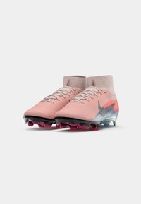 Sporta apavi ar rozā gradienta dizainu, adīta augšdaļa, zema potīte un melna tekstūru zole ar purpura akcentētām pīlēm.