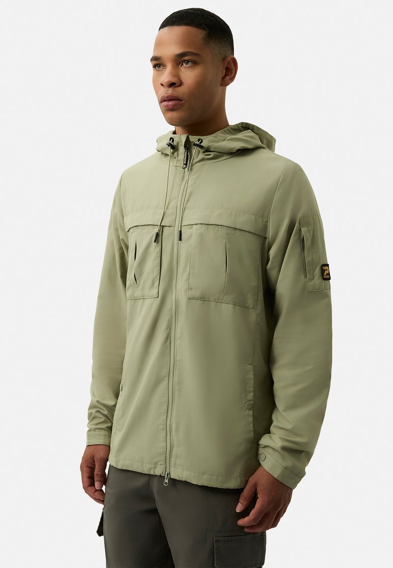 Light green hooded jacket made of smooth fabric. Features two front pockets, adjustable drawstrings, and a logo patch on the sleeve.