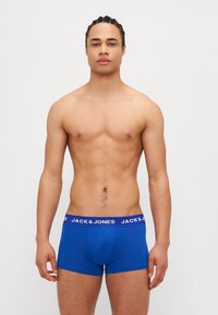 Blaue Boxershorts aus Baumwolle mit einem weißen elastischen Bund, auf dem "JACK & JONES" steht. Eng anliegend, glatte Textur.