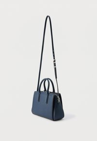 Granatowa torba wykonana z teksturowanego materiału. Posiada dwie krótkie rączki oraz długi, regulowany pasek, z zamkiem błyskawicznym u góry.