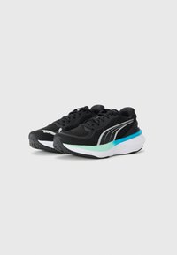 Zapatillas deportivas negras con una parte superior de malla texturizada, con detalles en plata, una entresuela blanca y un detalle en turquesa en el talón.