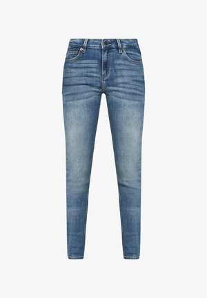 Kitsad teksad heledas sinises denimis, mis on kulunud ja erksad, viie tasku kujundusega ning peent õmblemist esipinnal. Klassikalised vöösilmused ja metallist nupp.