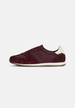 Burgundy suede sneaker with smooth leather accents, round toe, lace-up closure, and a light brown rubber sole.
