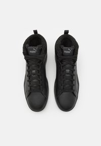 Pair of black Puma high-top sneakers with laces and fleece lining, shown from above on white background.