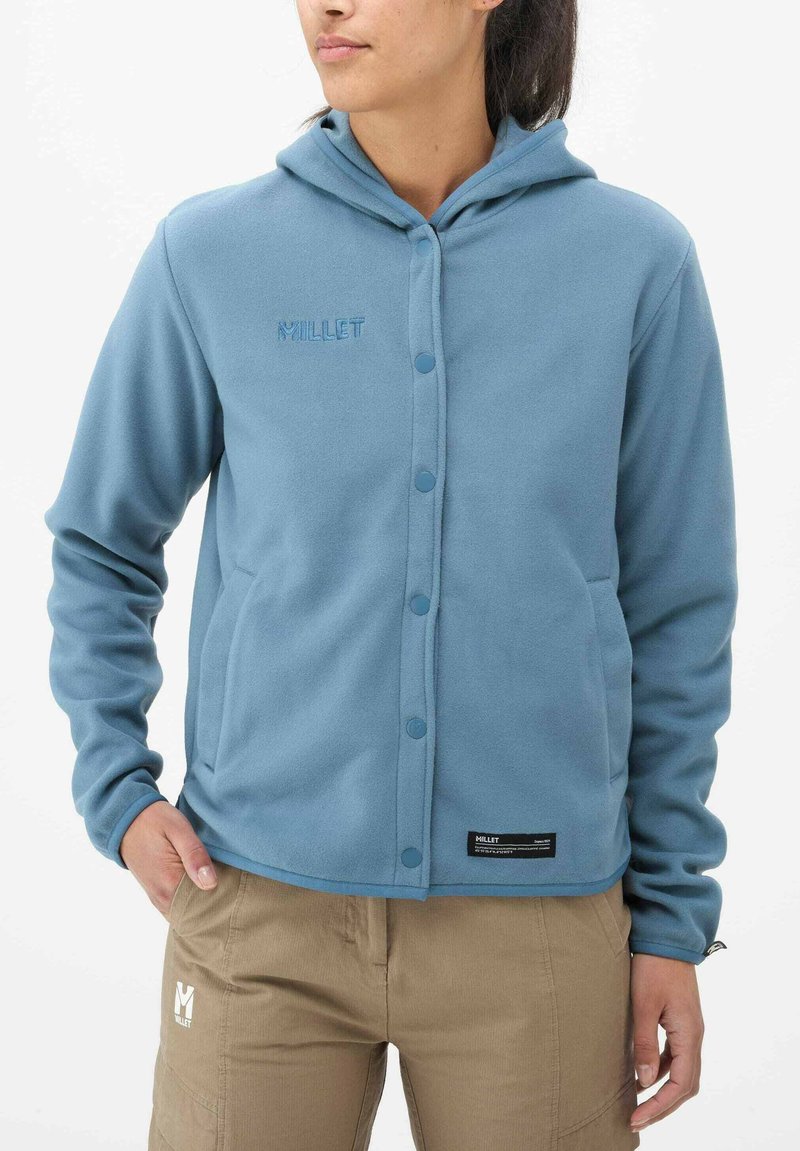 Light blue fleece jacket with a hood, snap button closure, and side pockets. Features embroidered brand logo and smooth texture.