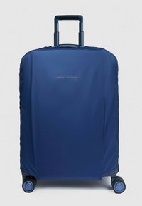 Valigia blu navy con guscio morbido, maniglia retrattile e quattro ruote per la mobilità. Presenta un logo sul pannello frontale e una texture liscia.