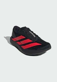 Black running shoe with red accent stripes, lightweight design, mesh upper, cushioned sole, and AMB branding on the side.