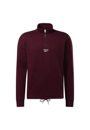 Bordowy pulower Reebok z długim rękawem, półzamkiem, kieszenią kangurzą, ściągaczem w dolnej części i stójką.
