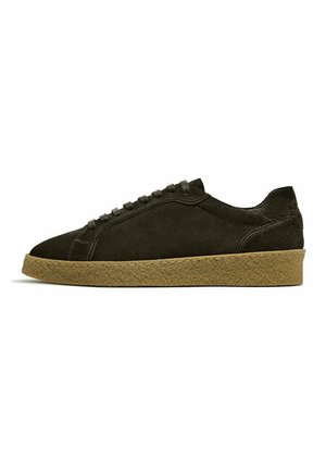 Dark brown suede low-top sneaker with matching laces and textured light brown rubber sole, side view on white background.