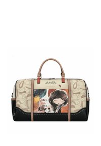 Sac de voyage beige et noir avec illustration et texte, doté d'une finition synthétique lisse, de doubles poignées et d'accents en cuir contrastants.