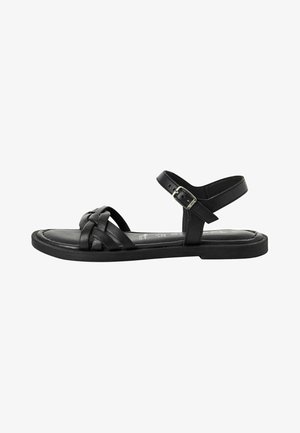 Black leather sandal with braided upper design, adjustable ankle strap, flat sole, and smooth texture. Suitable for casual wear.