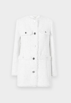 Balts tvīda žakets ar teksturētu audumu, kas aprīkots ar divām priekšējām kabatām, augstu apkakli un sudraba pogām aizdarei un akcentiem.