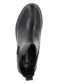 Bottines en cuir noir avec des panneaux élastiques sur les côtés, un bout arrondi et une languette au niveau du talon. Présente un contraste de couture le long de la semelle.