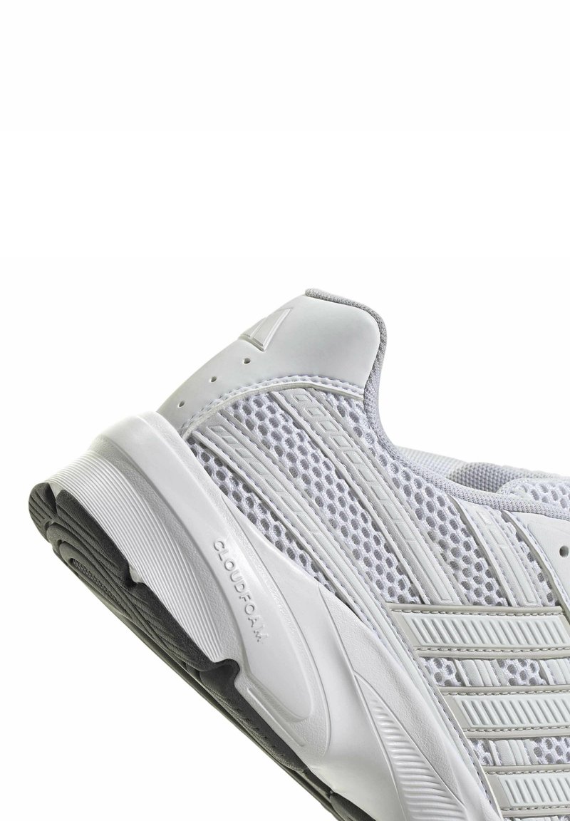 White athletic shoe featuring breathable mesh upper, gray accents, and textured rubber sole labeled "CLOUDFOAM." Rounded toe design.