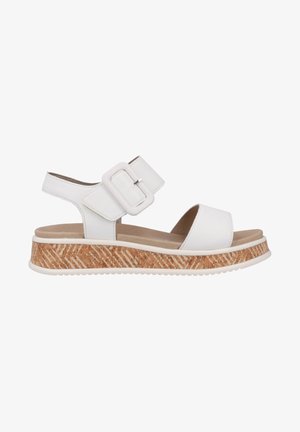 Weiße Sandalen mit einem breiten Riemen und quadrischer Schnalle. Sie verfügen über eine strukturierte Korkplattform mit Zickzackmustern und einem weichen Fußbett.