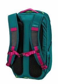 Teal backpack with pink straps and accents. Features padded mesh back, adjustable chest and waist straps, and a logo on the front.