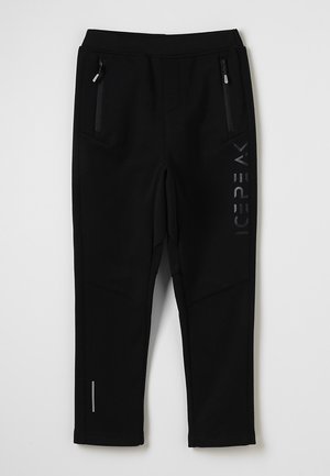 Pantalons de sport noirs au tissu lisse, dotés de deux poches latérales zippées et d'un logo noir mat sur le côté.