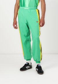 adidas Originals - WARM UP  - Tracksuit bottoms - energy green Thumbnail Image 1