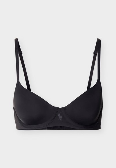 Μαύρο σουτιέν με μπανέλα, λεπτές ρυθμιζόμενες τιράντες και μικρό ανάγλυφο λογότυπο στο κέντρο μπροστά, σε απλό φόντο.