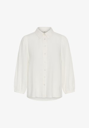 Valkoinen pitkähiha pusero, jossa napillinen etuosa, terävä kaulus ja kevyestä kankaasta valmistetut hieman kerätyt hihansuut.