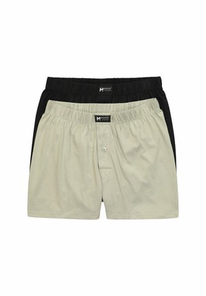 Zwei Paare Herren-Boxershorts mit elastischem Bund, eines beige mit Knopfleiste und eines schwarz, auf weißem Hintergrund gestapelt.