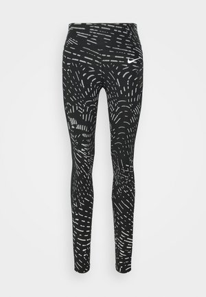 Leggings noirs avec une taille haute, ornés d'un motif abstrait blanc. Fabriqués à partir d'un matériau extensible, conçus pour les vêtements de sport.