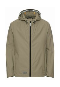Beige wasserdichte Jacke mit Kapuze, vorderem Reißverschluss, elastischen Bündchen und einem Logopatch. Sie hat schwarze Akzente und ein gefüttertes Innenfutter.