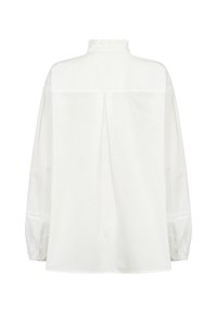 White, long-sleeve blouse with a high neck, ruffle detail, and gathered cuffs. Features a back pleat for added ease and movement.