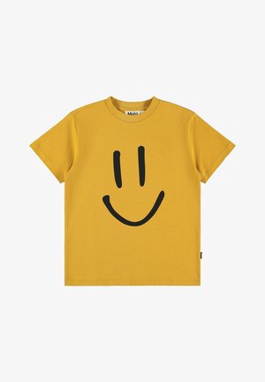 Camiseta amarilla de manga corta con una gran cara sonriente negra en el frente y un cuello redondo.