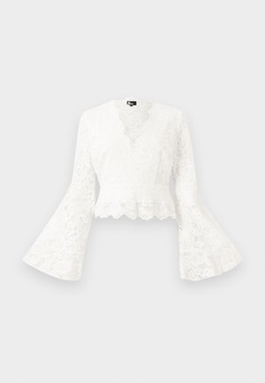 White lace cropped jacket with bell sleeves, featuring a scalloped hem and a deep V-neck design. Soft texture with intricate floral patterns.