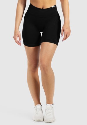 Zwarte hooglopende shorts van rekbare stof, met een aansluitend ontwerp, een soepele textuur en een lengte tot halverwege de dij. Gemaakt om te dragen met witte sneakers.